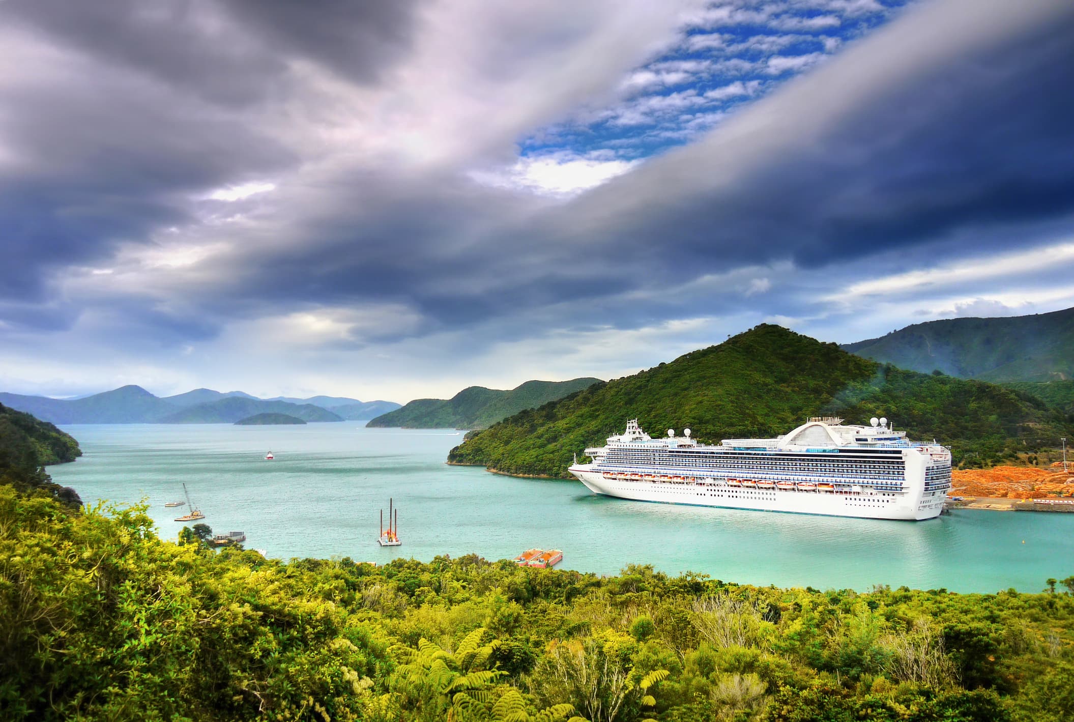 A cruise ship navigates a waterway in beautiful New Zealand mountains