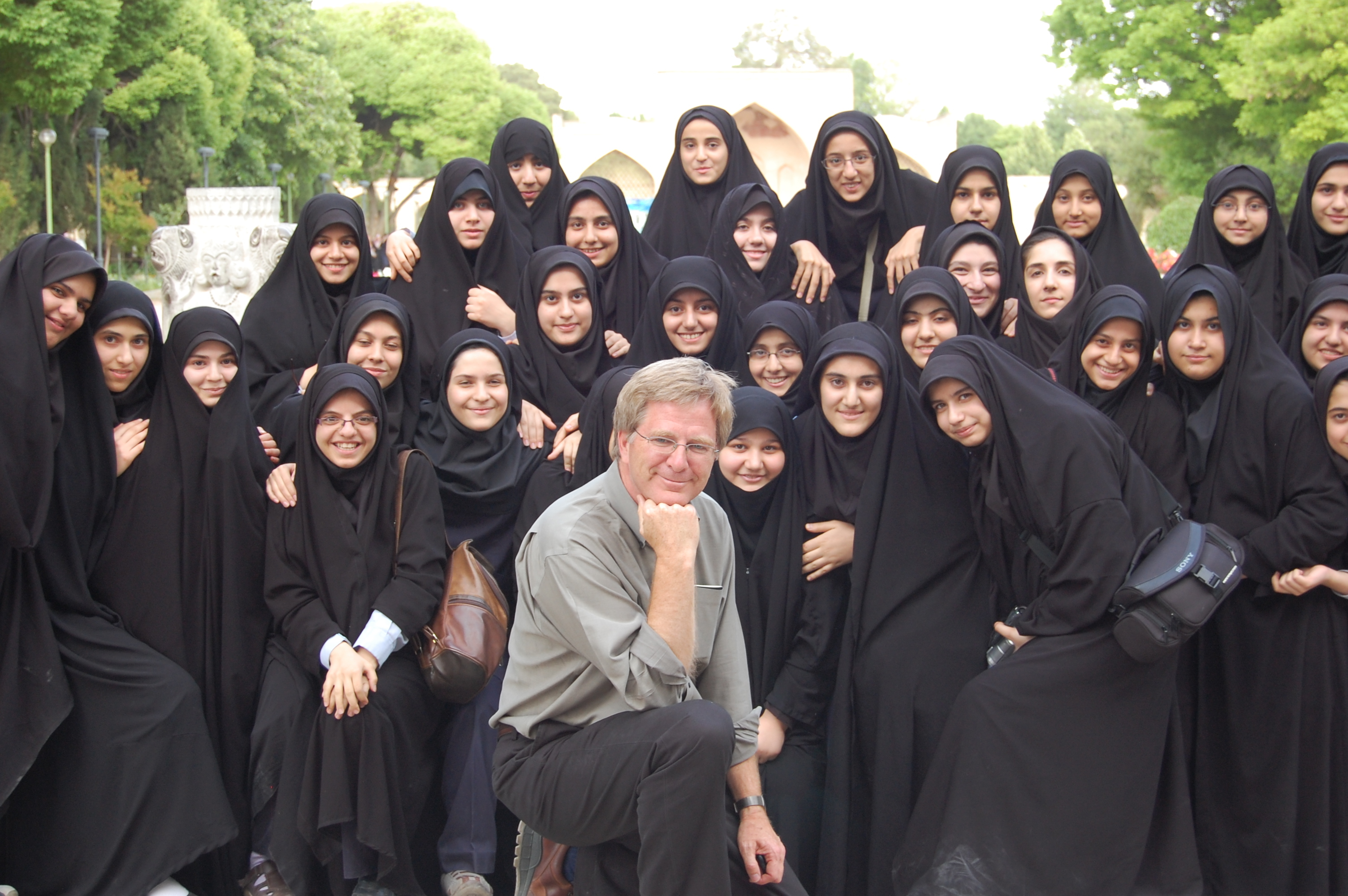 Rick Steves poses with veiled women in Iran in 2008.