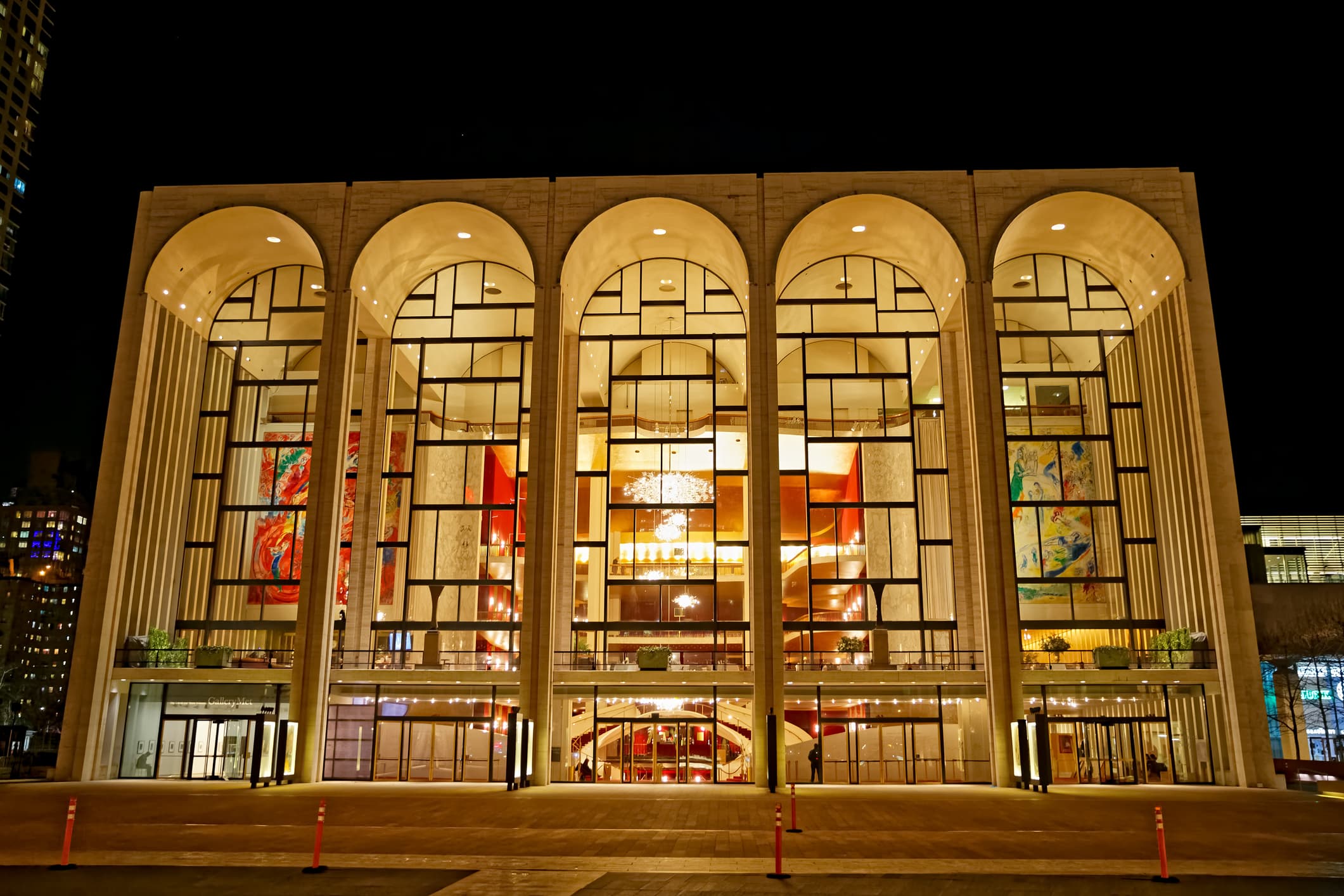 A view of the front windows and chandeliers of the Metropolitan Opera House in New York City.